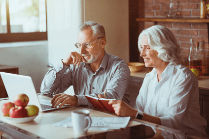 older couple smiling at computer